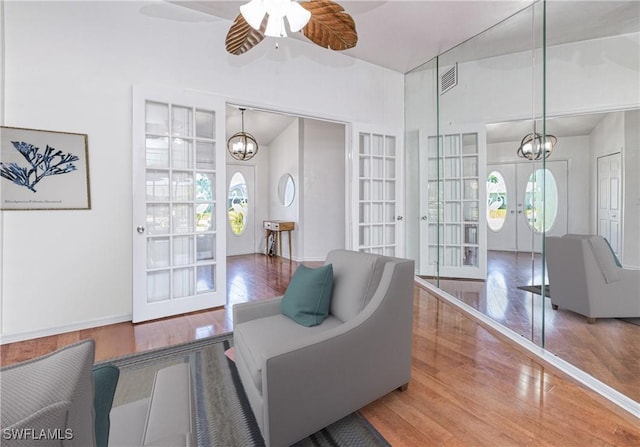 205 SW 42nd Ter, Cape Coral, FL 33914 - living area featuring french doors, wood finished floors, a chandelier, ceiling fan, and lofted ceiling