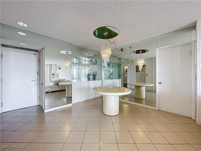 20225 NE 34th Ct, Miami, FL 33180 - bathroom with a textured ceiling, an inviting chandelier, tile patterned flooring, and visible vents