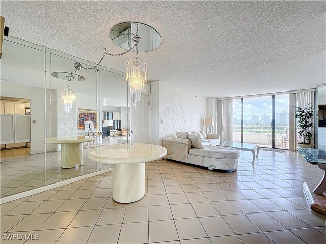 20225 NE 34th Ct, Miami, FL 33180 - living area with light tile patterned flooring, a textured ceiling, an inviting chandelier, and floor to ceiling windows