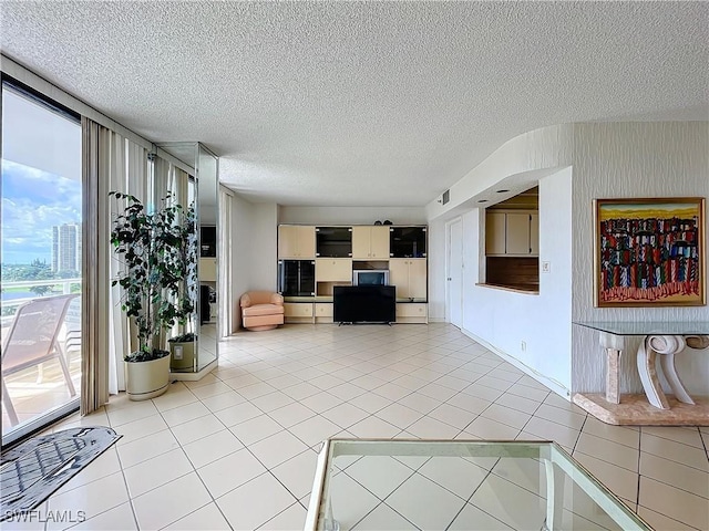 20225 NE 34th Ct, Miami, FL 33180 - interior space with light tile patterned floors, a wealth of natural light, and a textured ceiling