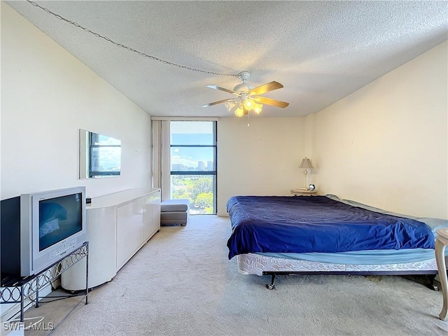 20225 NE 34th Ct, Miami, FL 33180 - bedroom featuring a textured ceiling, light colored carpet, ceiling fan, and a wall of windows