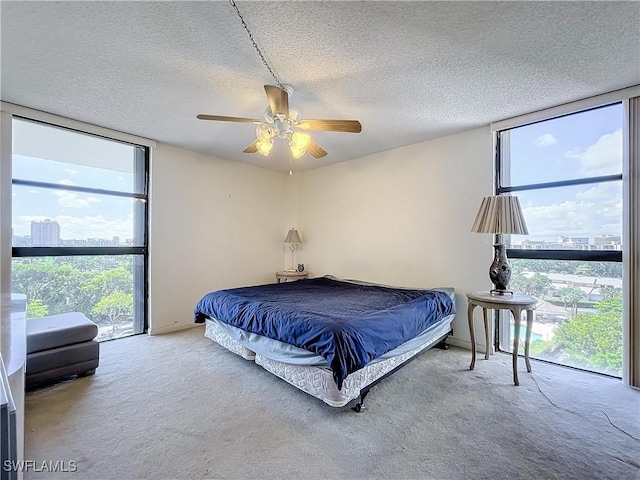 20225 NE 34th Ct, Miami, FL 33180 - carpeted bedroom with expansive windows, multiple windows, a textured ceiling, and ceiling fan