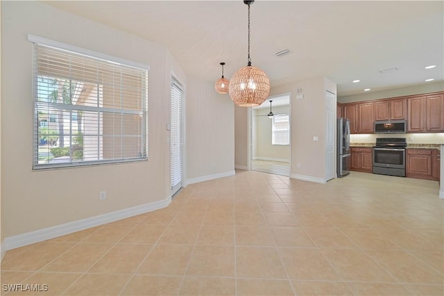 10486 Winged Elm Ln, Fort Myers, FL 33913 - kitchen with appliances with stainless steel finishes, a chandelier, light tile patterned floors, pendant lighting, and recessed lighting