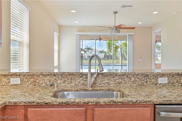 10486 Winged Elm Ln, Fort Myers, FL 33913 - kitchen featuring a ceiling fan, brown cabinetry, light stone countertops, and recessed lighting