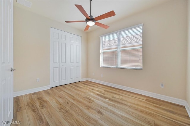 10486 Winged Elm Ln, Fort Myers, FL 33913 - unfurnished bedroom with light wood finished floors, a closet, and ceiling fan