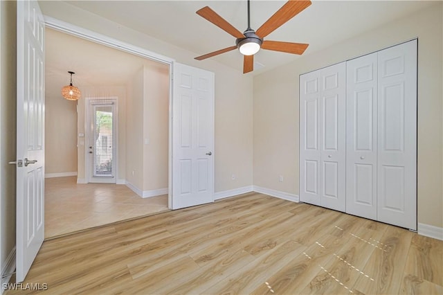 10486 Winged Elm Ln, Fort Myers, FL 33913 - unfurnished bedroom with light wood-style floors, a ceiling fan, and a closet