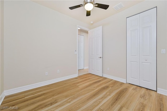10486 Winged Elm Ln, Fort Myers, FL 33913 - unfurnished bedroom with light wood-style flooring, a closet, and ceiling fan