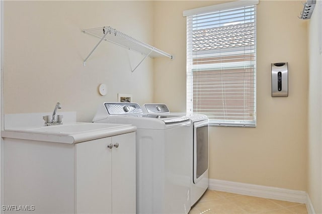 10486 Winged Elm Ln, Fort Myers, FL 33913 - washroom with cabinet space, washer and dryer, and light tile patterned floors
