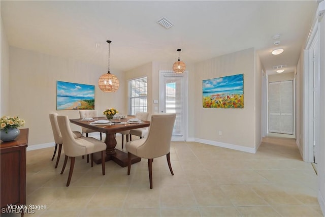 10486 Winged Elm Ln, Fort Myers, FL 33913 - dining area with light tile patterned flooring and a chandelier