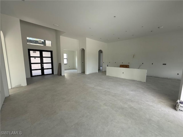 2481 24th Ave NE, Naples, FL 34120 - unfurnished living room featuring arched walkways