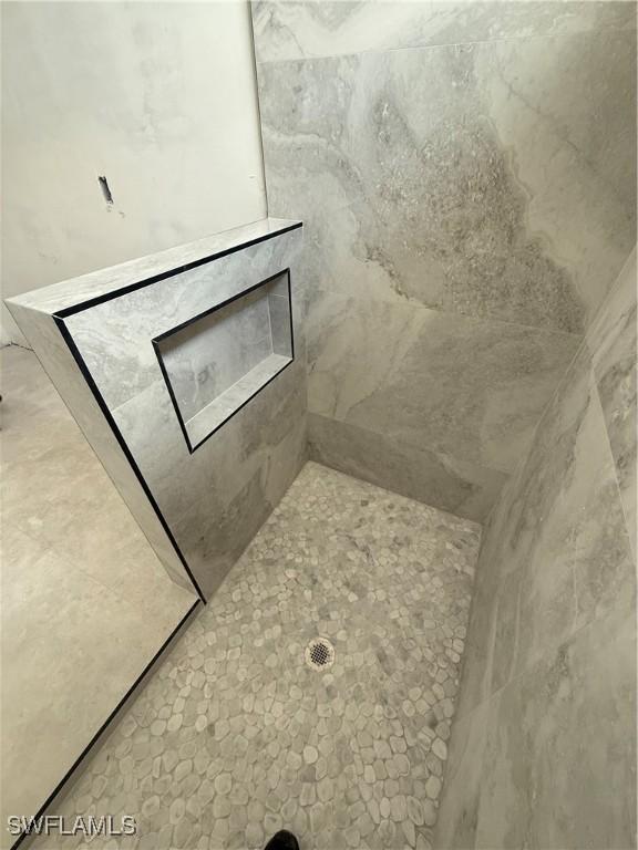 2481 24th Ave NE, Naples, FL 34120 - bathroom featuring a tile shower
