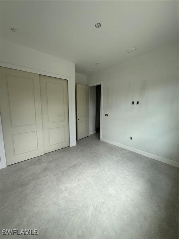 2481 24th Ave NE, Naples, FL 34120 - unfurnished bedroom featuring a closet and concrete flooring