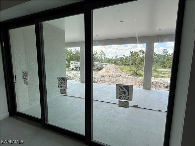 2481 24th Ave NE, Naples, FL 34120 - doorway to outside with finished concrete flooring