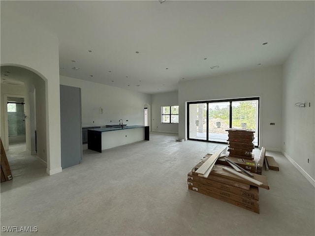 2481 24th Ave NE, Naples, FL 34120 - living area with arched walkways and light colored carpet