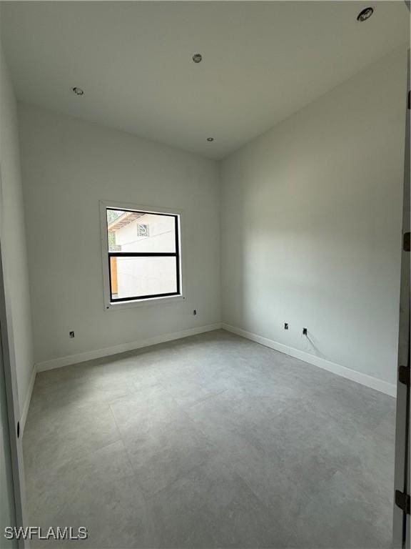 2481 24th Ave NE, Naples, FL 34120 - empty room featuring baseboards and concrete flooring