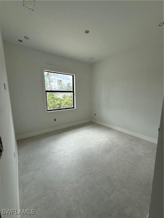 2481 24th Ave NE, Naples, FL 34120 - empty room featuring concrete flooring and baseboards