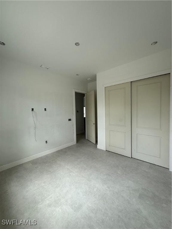 2481 24th Ave NE, Naples, FL 34120 - unfurnished bedroom featuring a closet and baseboards