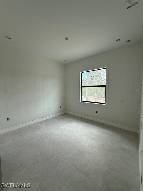 2481 24th Ave NE, Naples, FL 34120 - spare room with concrete floors and baseboards