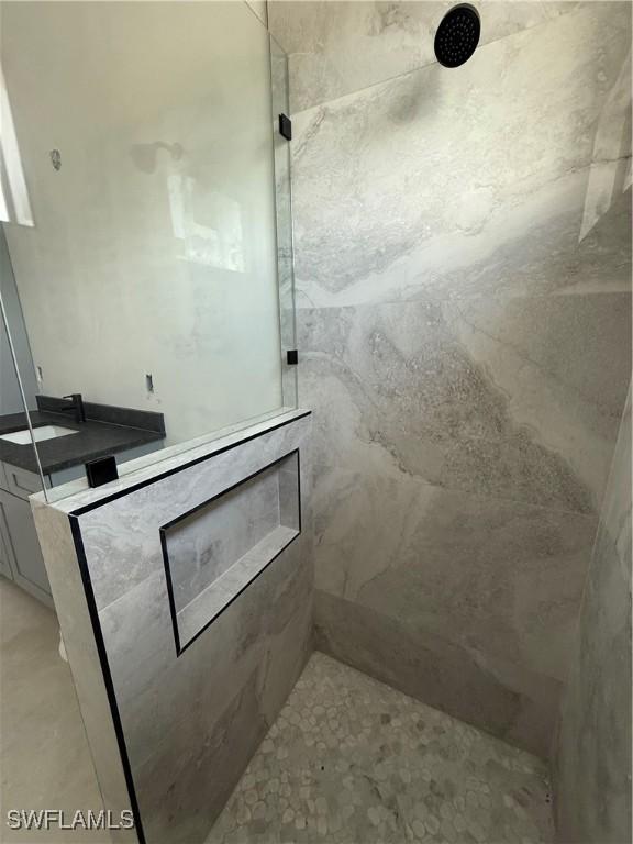 2481 24th Ave NE, Naples, FL 34120 - bathroom featuring a marble finish shower and vanity