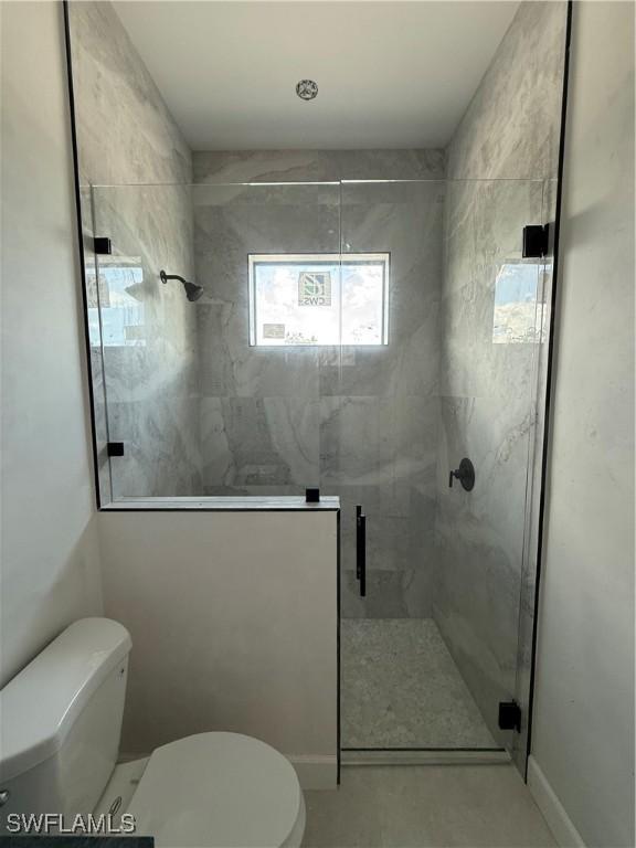 2481 24th Ave NE, Naples, FL 34120 - bathroom featuring toilet and a stall shower