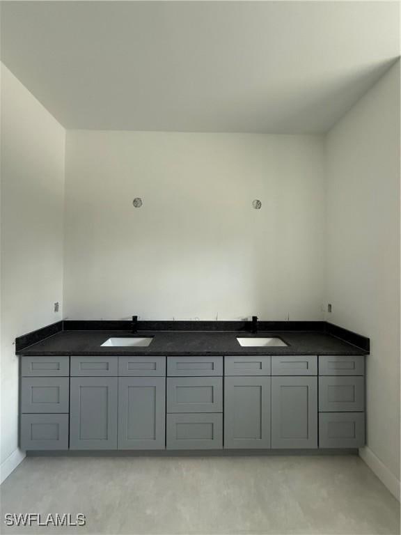 2481 24th Ave NE, Naples, FL 34120 - bathroom featuring baseboards and double vanity