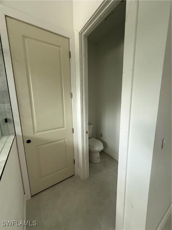 2481 24th Ave NE, Naples, FL 34120 - bathroom with toilet and concrete floors