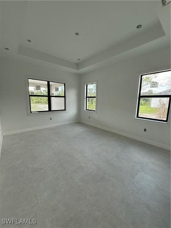 2481 24th Ave NE, Naples, FL 34120 - unfurnished room featuring a tray ceiling and baseboards