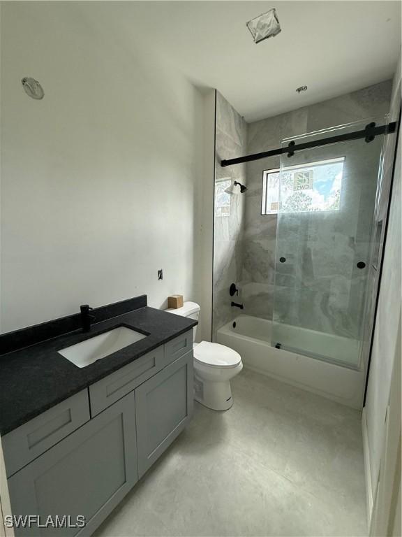 2481 24th Ave NE, Naples, FL 34120 - bathroom featuring vanity and combined bath / shower with glass door