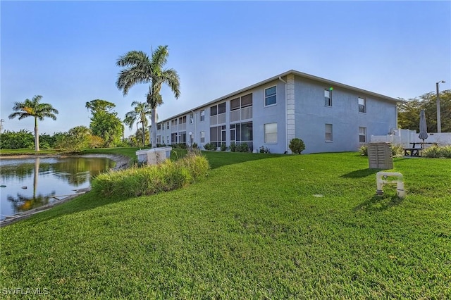 15030 Arbor Lakes Dr W Unit 201, North Fort Myers, FL 33917 - view of community featuring a yard and a water view