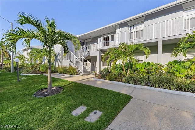 15030 Arbor Lakes Dr W Unit 201, North Fort Myers, FL 33917 - view of community featuring a yard and stairs