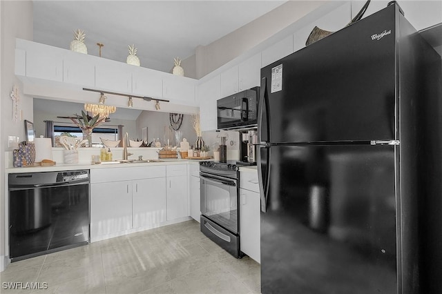 15030 Arbor Lakes Dr W Unit 201, North Fort Myers, FL 33917 - kitchen with white cabinets, light countertops, a sink, and black appliances