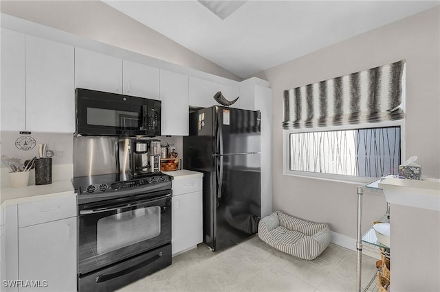15030 Arbor Lakes Dr W Unit 201, North Fort Myers, FL 33917 - kitchen with white cabinetry, light countertops, vaulted ceiling, and black appliances