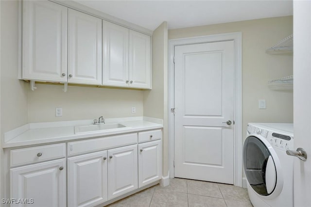 laundry area with a sink, light tile patterned floors, cabinet space, and washer / clothes dryer