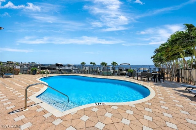 community pool featuring a patio area and fence