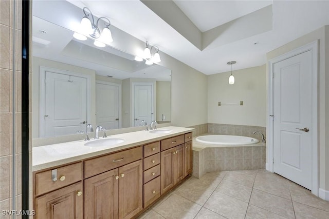 bathroom with a sink, a bath, tile patterned floors, and a tray ceiling