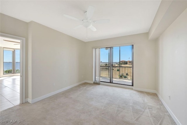 unfurnished room with ceiling fan, light colored carpet, plenty of natural light, and baseboards