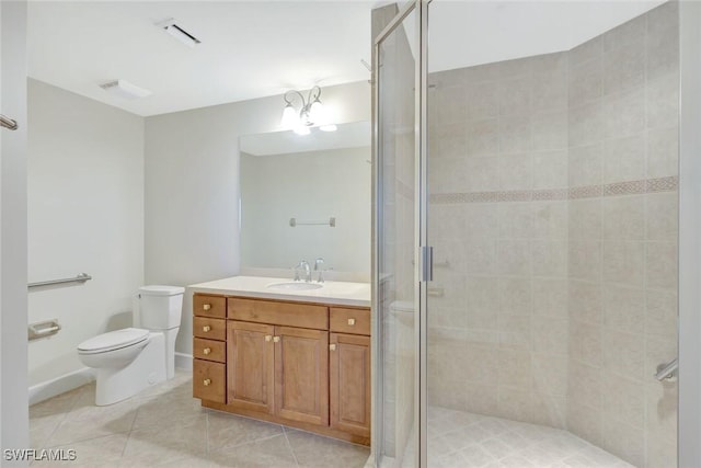 full bath with vanity, tile patterned floors, toilet, and a shower stall