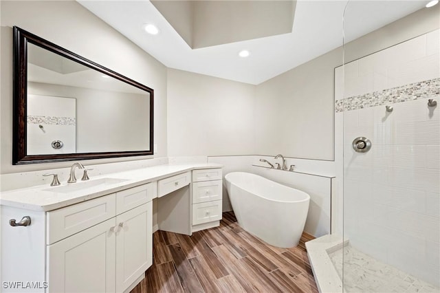bathroom with vanity, a walk in shower, and recessed lighting