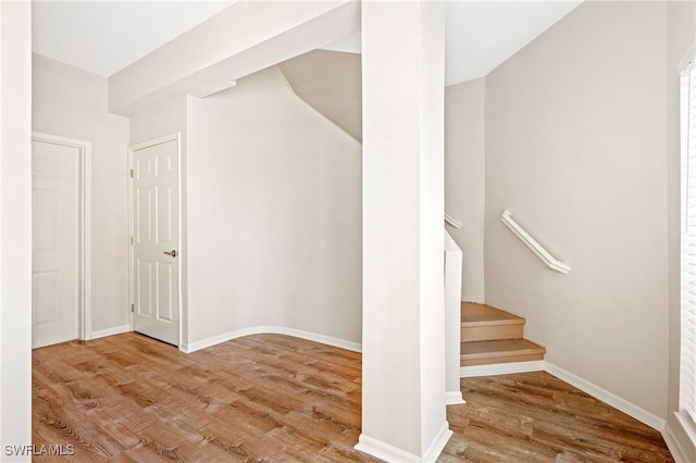 stairs with baseboards and wood finished floors
