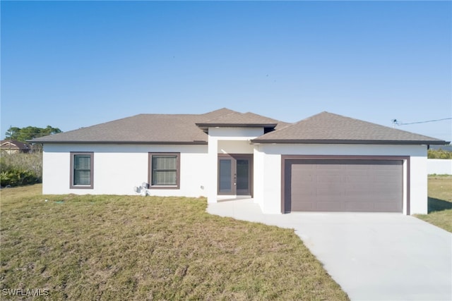 3403 53rd St W, Lehigh Acres, FL 33971 - prairie-style house featuring a front yard, an attached garage, driveway, and stucco siding