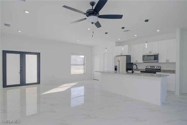 3403 53rd St W, Lehigh Acres, FL 33971 - kitchen with stainless steel appliances, marble finish floor, visible vents, and white cabinets