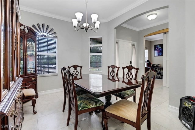 dining room featuring arched walkways, crown molding, a chandelier, light tile patterned floors, and baseboards