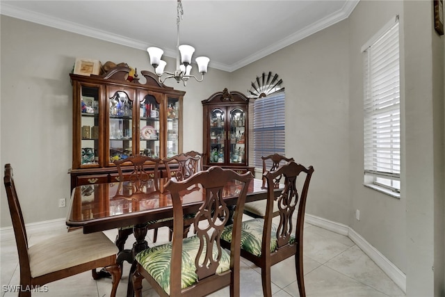 dining room with a chandelier, crown molding, light tile patterned floors, and baseboards