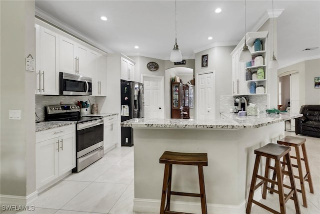 kitchen featuring stainless steel appliances, arched walkways, open shelves, backsplash, and recessed lighting