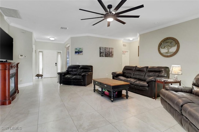 living area with ceiling fan, ornamental molding, a glass covered fireplace, light tile patterned floors, and arched walkways