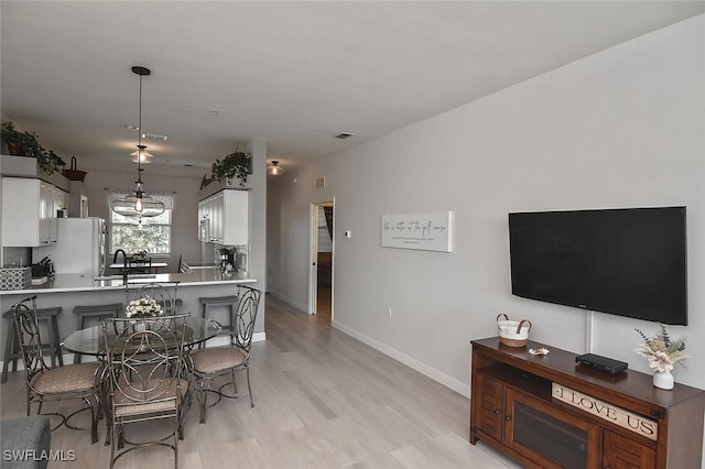 interior space with light wood finished floors and baseboards