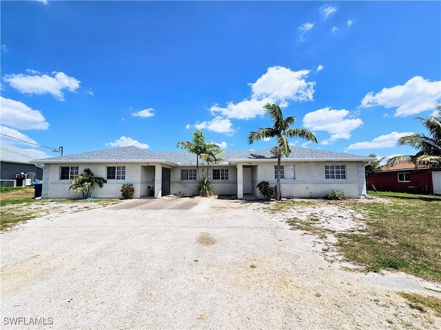 single story home with driveway and stucco siding