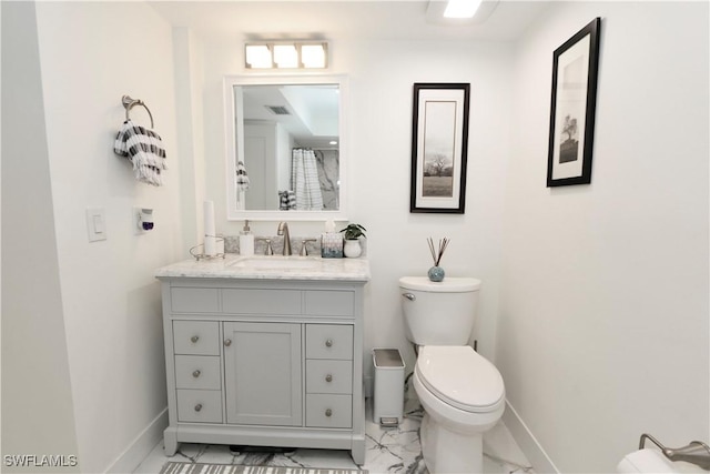 2061 Santa Barbara Blvd, Naples, FL 34116 - full bath with baseboards, toilet, vanity, and marble look tiles