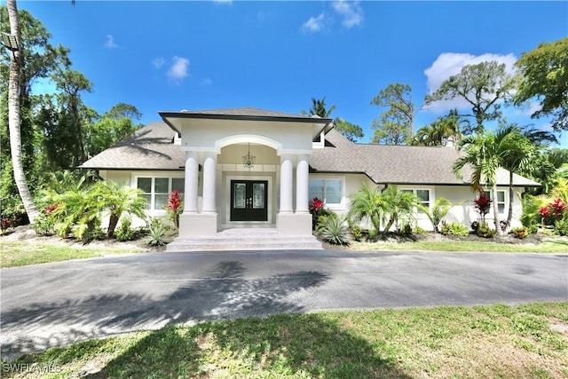 2061 Santa Barbara Blvd, Naples, FL 34116 - view of front of home with french doors, stucco siding, and a shingled roof