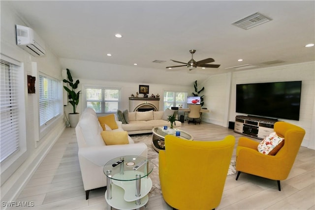 2061 Santa Barbara Blvd, Naples, FL 34116 - living room with a wall mounted AC, a ceiling fan, recessed lighting, a fireplace, and wood finished floors